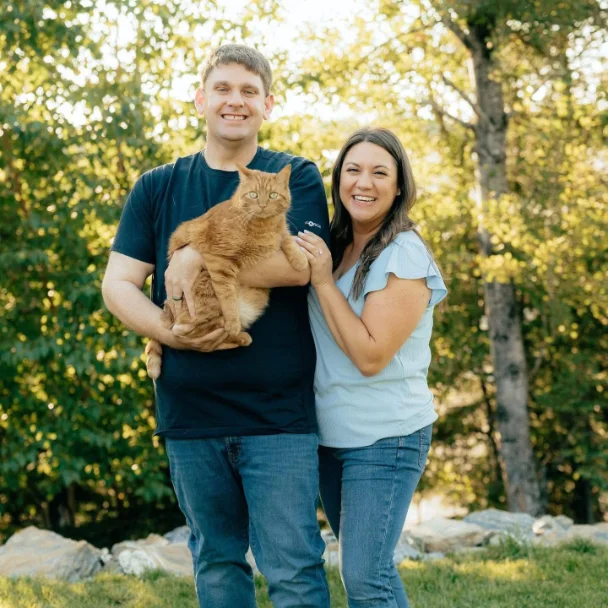 Ryan, Sabrina, and Tigger outdoors on a sunny day.